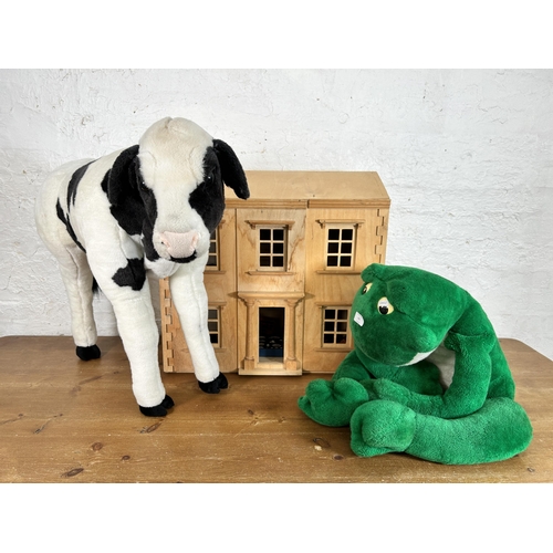 395 - Three items, one wooden doll's house with furniture and two animal soft toys