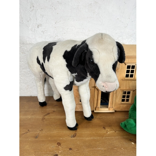 395 - Three items, one wooden doll's house with furniture and two animal soft toys