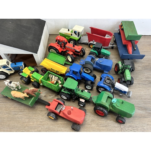 407 - Two boxes containing farm yard related model toys to include scratch built barn, animals, model trac... 