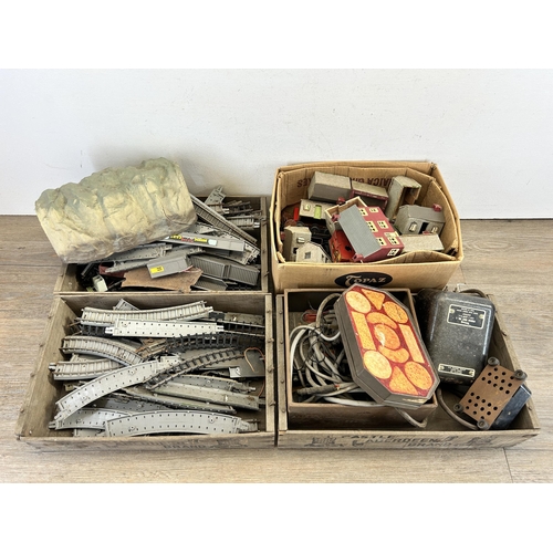 415 - Four boxes containing a large collection of mainly Tri-ang model railway accessories to include Brit... 