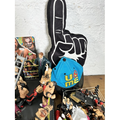 416 - A large collection of WWE wrestling action figurines and accessories to include over one hundred fig... 