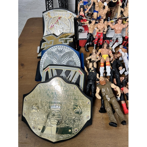 416 - A large collection of WWE wrestling action figurines and accessories to include over one hundred fig... 