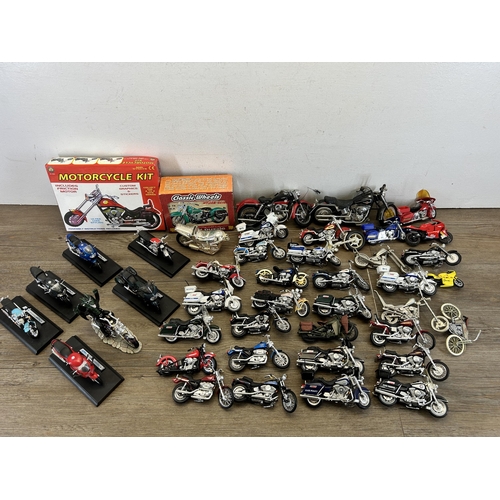 418 - A large collection of model motorcycles to include Welly Triumph TT600, Matchbox Harley Davidson, Ma... 