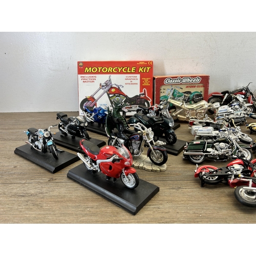 418 - A large collection of model motorcycles to include Welly Triumph TT600, Matchbox Harley Davidson, Ma... 