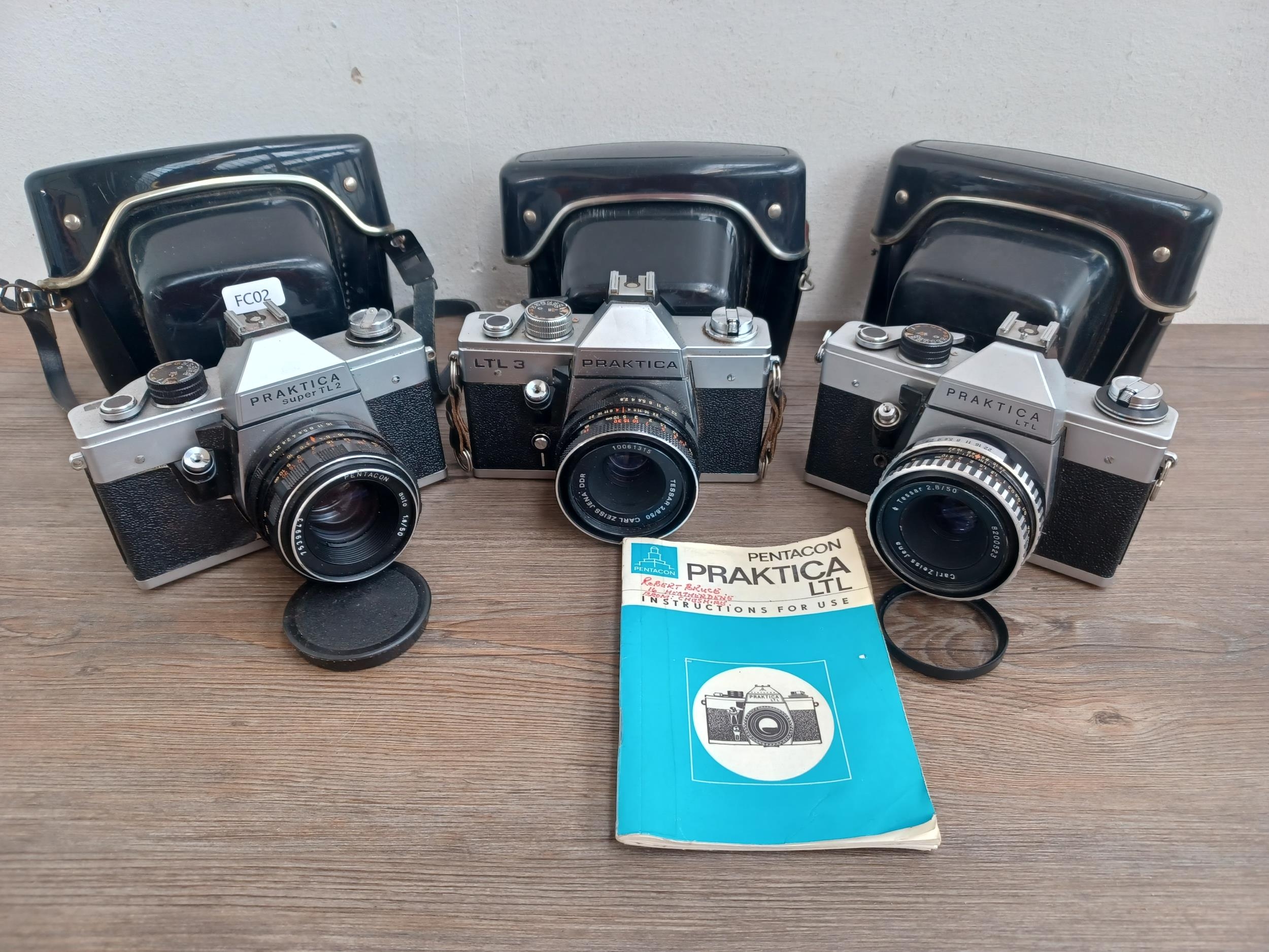 Three cased Pentacon Praktica 35mm SLR cameras, one Super TL2