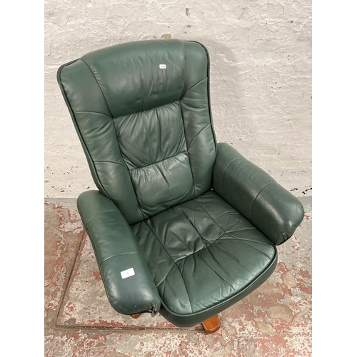 100 - A Stressless style green leather swivel reclining armchair