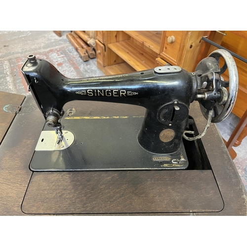 12 - A Singer treadle sewing machine with oak cabinet - serial no. EA868499