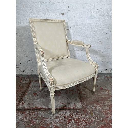 17 - A Louis XVI style white painted and fabric upholstered armchair