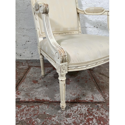 17 - A Louis XVI style white painted and fabric upholstered armchair