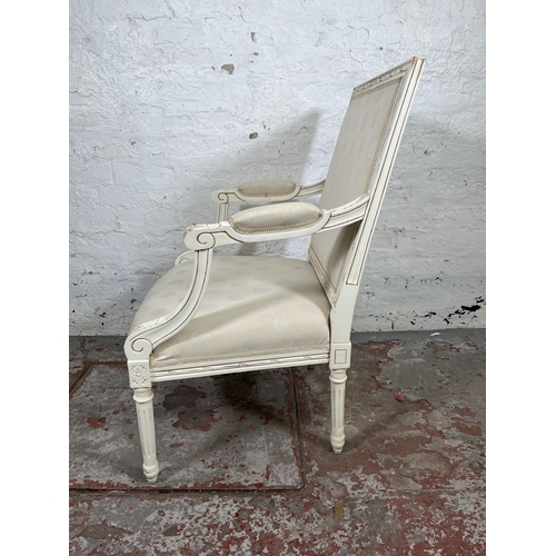 17 - A Louis XVI style white painted and fabric upholstered armchair