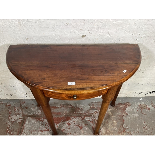 21 - A Georgian style mahogany half moon console table with single drawer