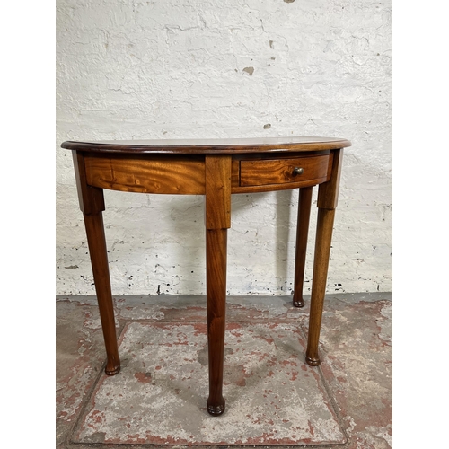 21 - A Georgian style mahogany half moon console table with single drawer