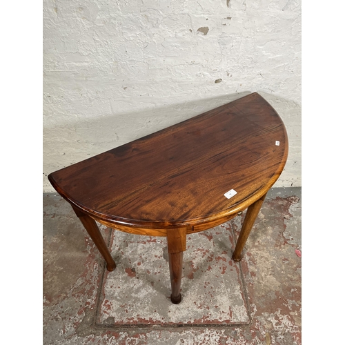 21 - A Georgian style mahogany half moon console table with single drawer