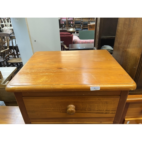 31 - A pair of Ameta Kauri Country bedside chests of three drawers