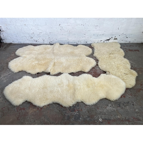 38 - Three sheepskin rugs to include Dunelm 170cm x 60cm etc.