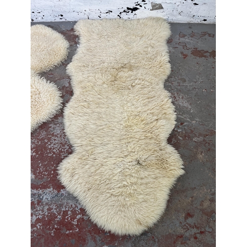 38 - Three sheepskin rugs to include Dunelm 170cm x 60cm etc.