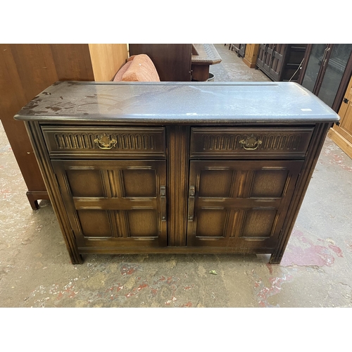 40A - A carved oak sideboard with two drawers and two cupboard doors