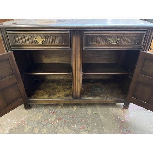 40A - A carved oak sideboard with two drawers and two cupboard doors