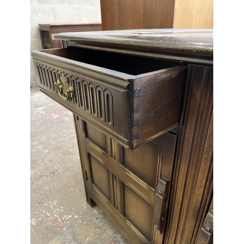 40A - A carved oak sideboard with two drawers and two cupboard doors