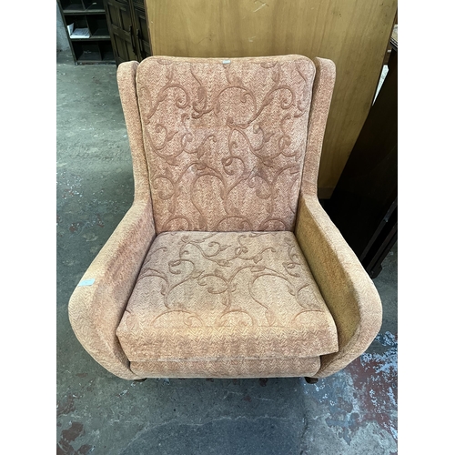 41 - A mid 20th century fabric upholstered and teak rocking armchair