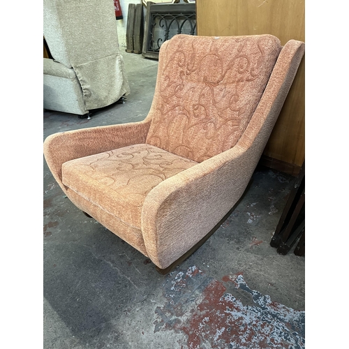 41 - A mid 20th century fabric upholstered and teak rocking armchair