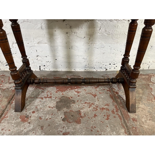 42 - A Victorian Aesthetic Movement mahogany side table with lower stretcher