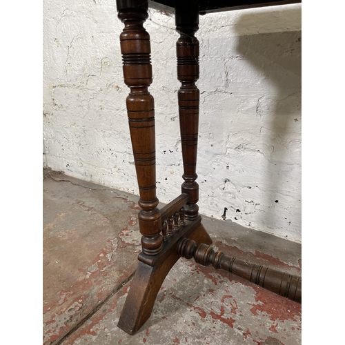 42 - A Victorian Aesthetic Movement mahogany side table with lower stretcher