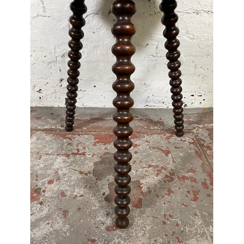 43 - A Victorian mahogany octagonal side table with bobbin turned supports