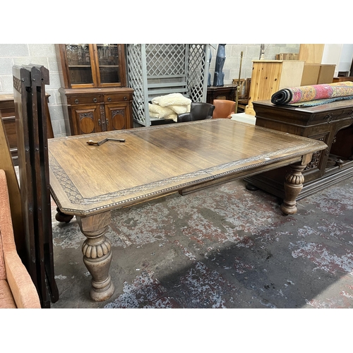 45 - A Victorian carved oak wind out dining table with four leaves - approx. 76cm high x 137cm wide x 220... 