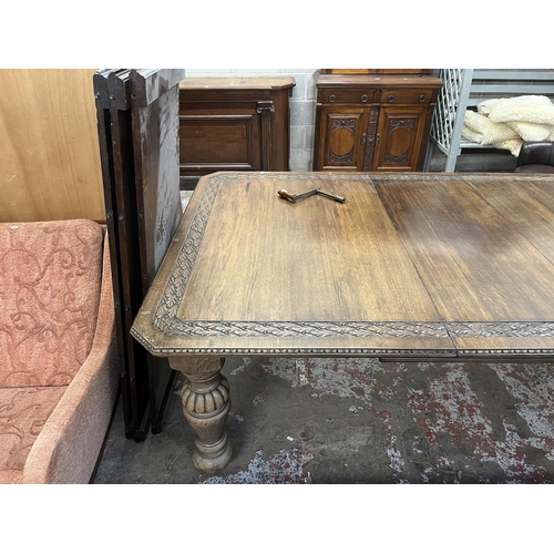 45 - A Victorian carved oak wind out dining table with four leaves - approx. 76cm high x 137cm wide x 220... 