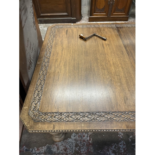 45 - A Victorian carved oak wind out dining table with four leaves - approx. 76cm high x 137cm wide x 220... 