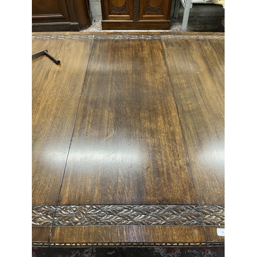 45 - A Victorian carved oak wind out dining table with four leaves - approx. 76cm high x 137cm wide x 220... 