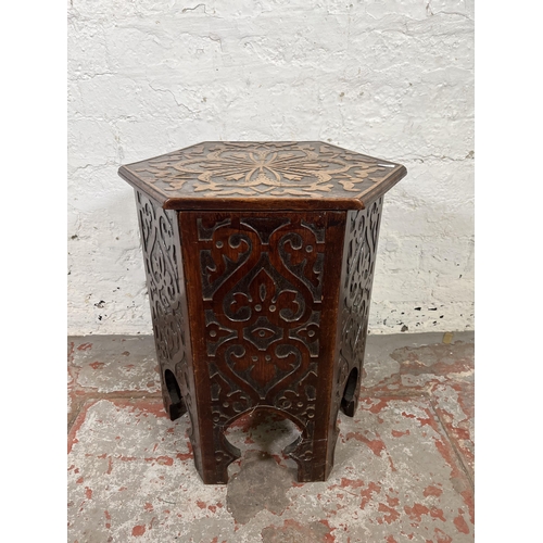 49 - A late 19th/early 20th century Anglo Indian carved mahogany hexagonal side table with hinged lid