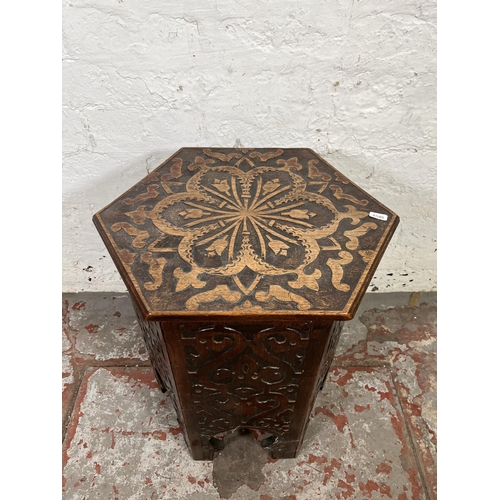 49 - A late 19th/early 20th century Anglo Indian carved mahogany hexagonal side table with hinged lid