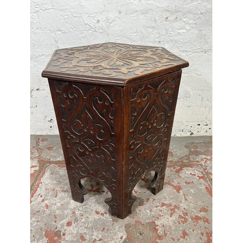 49 - A late 19th/early 20th century Anglo Indian carved mahogany hexagonal side table with hinged lid