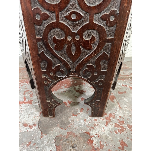 49 - A late 19th/early 20th century Anglo Indian carved mahogany hexagonal side table with hinged lid