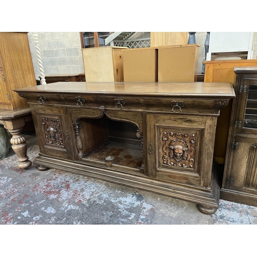 50 - A 19th century carved oak sideboard with three drawers and two cupboard doors - approx. 101cm high x... 