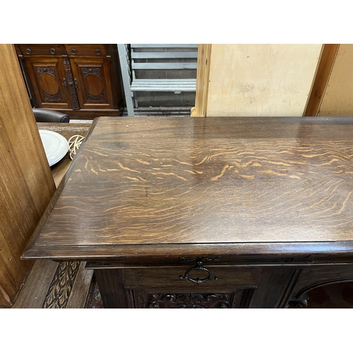 50 - A 19th century carved oak sideboard with three drawers and two cupboard doors - approx. 101cm high x... 