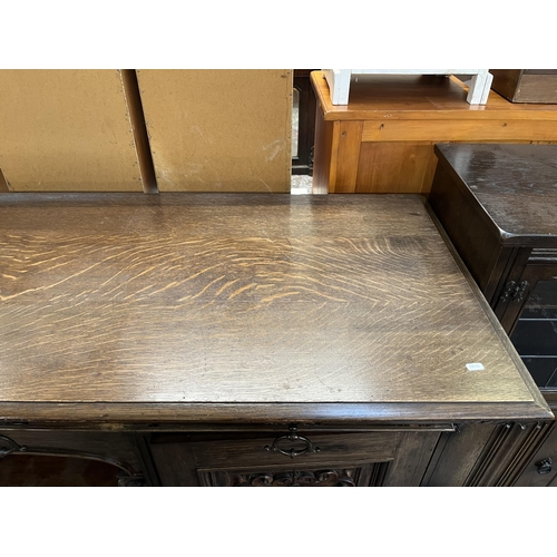 50 - A 19th century carved oak sideboard with three drawers and two cupboard doors - approx. 101cm high x... 