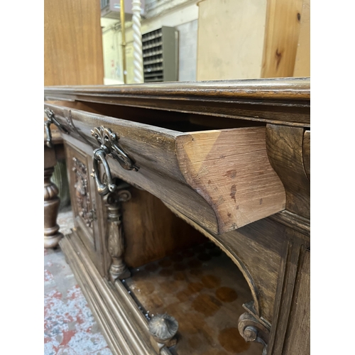 50 - A 19th century carved oak sideboard with three drawers and two cupboard doors - approx. 101cm high x... 