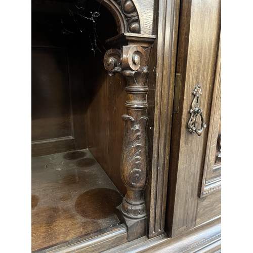 50 - A 19th century carved oak sideboard with three drawers and two cupboard doors - approx. 101cm high x... 