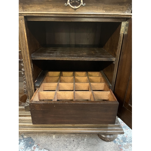 50 - A 19th century carved oak sideboard with three drawers and two cupboard doors - approx. 101cm high x... 