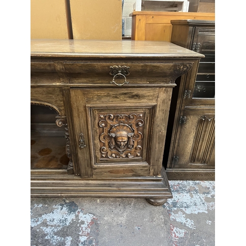 50 - A 19th century carved oak sideboard with three drawers and two cupboard doors - approx. 101cm high x... 