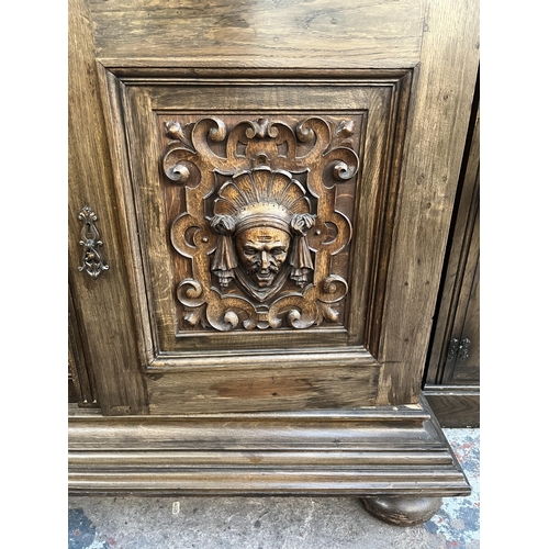 50 - A 19th century carved oak sideboard with three drawers and two cupboard doors - approx. 101cm high x... 