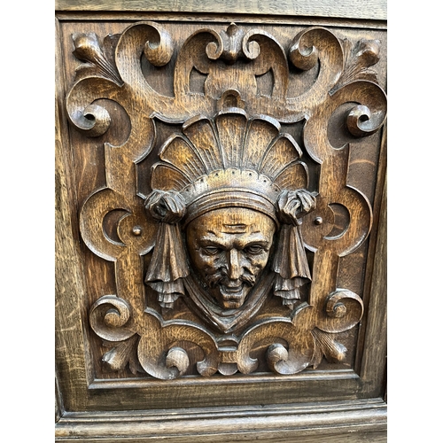 50 - A 19th century carved oak sideboard with three drawers and two cupboard doors - approx. 101cm high x... 