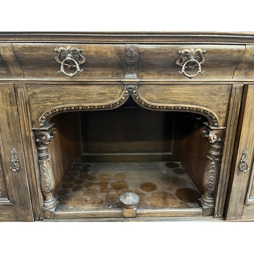 50 - A 19th century carved oak sideboard with three drawers and two cupboard doors - approx. 101cm high x... 