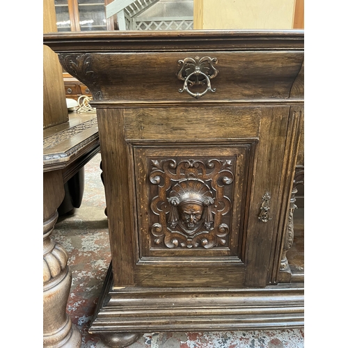 50 - A 19th century carved oak sideboard with three drawers and two cupboard doors - approx. 101cm high x... 