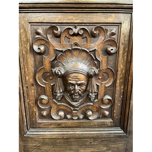 50 - A 19th century carved oak sideboard with three drawers and two cupboard doors - approx. 101cm high x... 