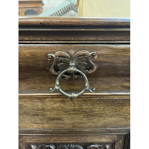 50 - A 19th century carved oak sideboard with three drawers and two cupboard doors - approx. 101cm high x... 