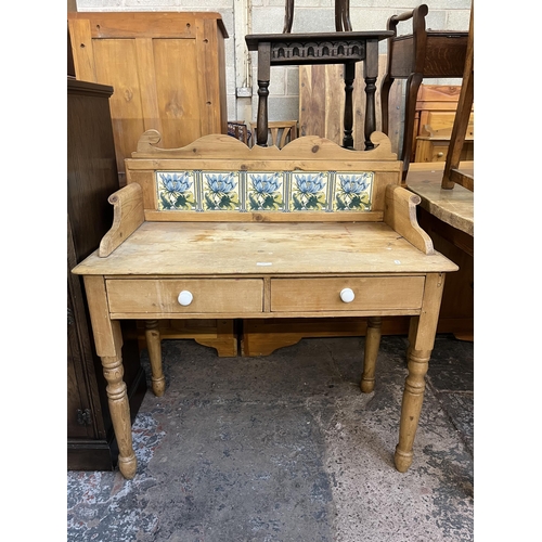 54 - A Victorian pine wash stand with two drawers and ceramic tile inserts